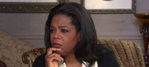 Oprah Winfrey, the most dangerous woman in the world, sitting in an armchair debating Bill Keller of LivePrayer.