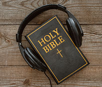 A smartphone and headphones to listen to a daily audio Bible reading as part of a Bible study.