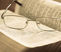 Eyeglasses on top of a Bible where study is spontaneous and flexible when you can search passages in different translations.
